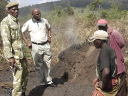 KWS officials chat with some of the Mau Forest Complex occupants. The occupants are heeding calls from the Government to surrender title deeds of land situated in water catchment areas.